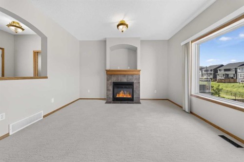 744 Luxstone Landing Sw, Airdrie, AB - Indoor With Fireplace