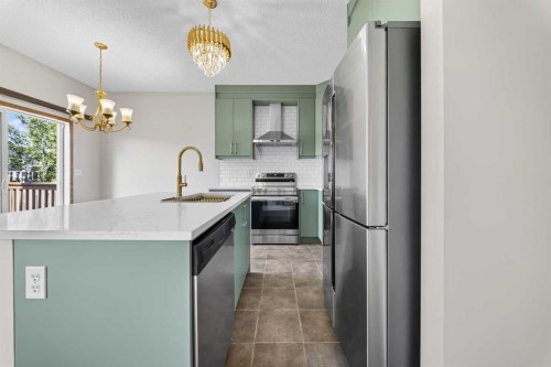 744 Luxstone Landing Sw, Airdrie, AB - Indoor Photo Showing Kitchen With Upgraded Kitchen