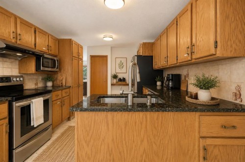 132 Scenic Cove Circle Nw, Calgary, AB - Indoor Photo Showing Kitchen With Double Sink