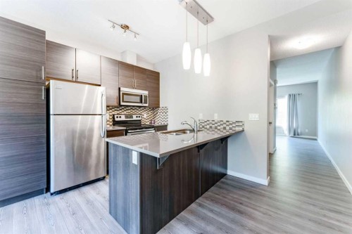 349-130 New Brighton Way Se, Calgary, AB - Indoor Photo Showing Kitchen With Stainless Steel Kitchen With Double Sink With Upgraded Kitchen