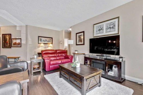 2110-15 Sunset Square, Cochrane, AB - Indoor Photo Showing Living Room