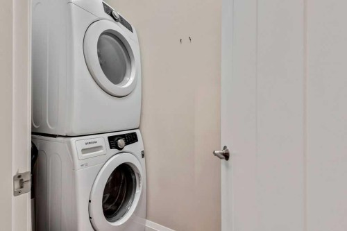 2110-15 Sunset Square, Cochrane, AB - Indoor Photo Showing Laundry Room