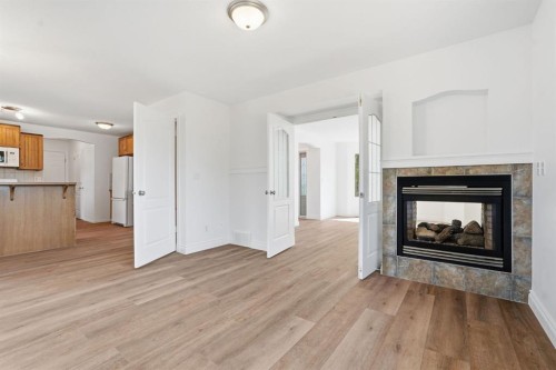 763 Stonehaven Drive, Carstairs, AB - Indoor Photo Showing Living Room With Fireplace