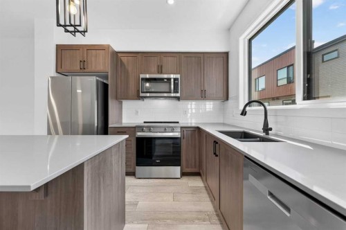 405-81 Midtown Boulevard Sw, Airdrie, AB - Indoor Photo Showing Kitchen With Double Sink With Upgraded Kitchen