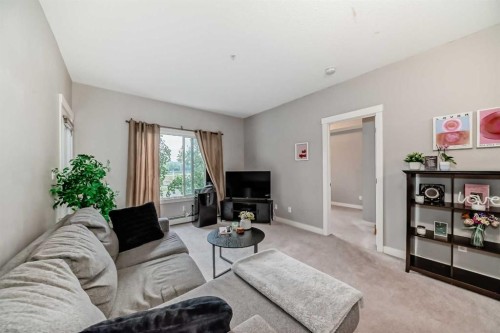 211-3950 46 Avenue Nw, Calgary, AB - Indoor Photo Showing Living Room