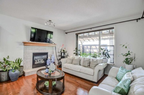 225 Chapala Drive Se, Calgary, AB - Indoor Photo Showing Living Room With Fireplace