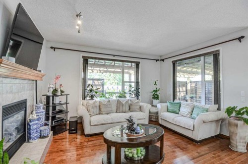 225 Chapala Drive Se, Calgary, AB - Indoor Photo Showing Living Room With Fireplace
