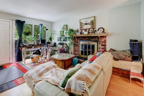 7624 34 Avenue Nw, Calgary, AB - Indoor Photo Showing Living Room With Fireplace