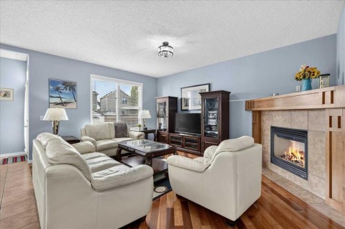 18 Copperstone Drive Se, Calgary, AB - Indoor Photo Showing Living Room With Fireplace