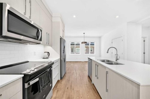 308-135 Belmont Passage Sw, Calgary, AB - Indoor Photo Showing Kitchen With Double Sink With Upgraded Kitchen