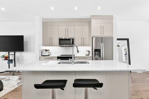308-135 Belmont Passage Sw, Calgary, AB - Indoor Photo Showing Kitchen With Stainless Steel Kitchen With Double Sink With Upgraded Kitchen