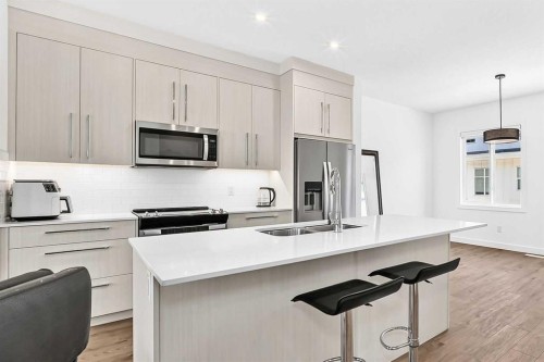 308-135 Belmont Passage Sw, Calgary, AB - Indoor Photo Showing Kitchen With Stainless Steel Kitchen With Double Sink With Upgraded Kitchen