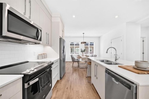 308-135 Belmont Passage Sw, Calgary, AB - Indoor Photo Showing Kitchen With Double Sink With Upgraded Kitchen