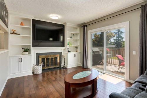 32 Berkley Place Nw, Calgary, AB - Indoor Photo Showing Living Room With Fireplace