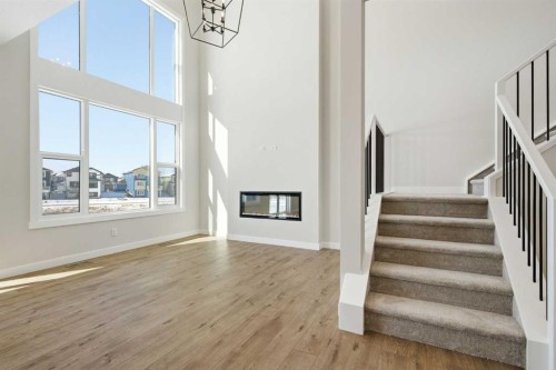 358 Kinniburgh Loop, Chestermere, AB - Indoor Photo Showing Other Room With Fireplace