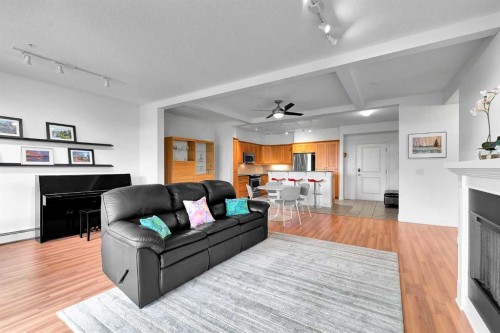 2105-10221 Tuscany Boulevard Nw, Calgary, AB - Indoor Photo Showing Living Room With Fireplace