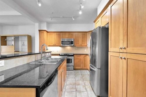 2105-10221 Tuscany Boulevard Nw, Calgary, AB - Indoor Photo Showing Kitchen With Stainless Steel Kitchen With Double Sink
