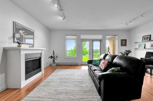 2105-10221 Tuscany Boulevard Nw, Calgary, AB - Indoor Photo Showing Living Room With Fireplace