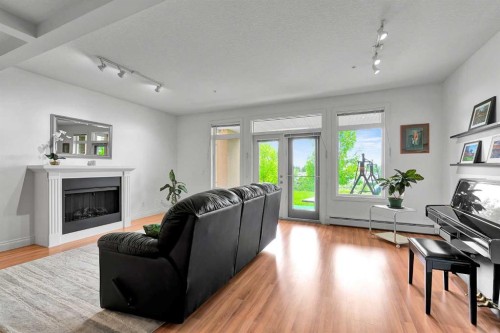 2105-10221 Tuscany Boulevard Nw, Calgary, AB - Indoor Photo Showing Living Room With Fireplace