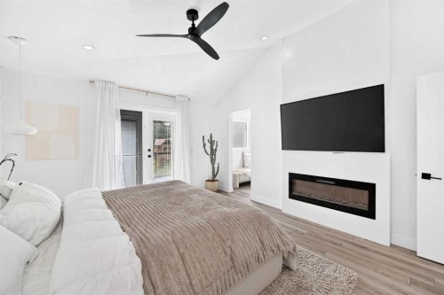 10909 Hidden Valley Drive Nw, Calgary, AB - Indoor Photo Showing Bedroom With Fireplace