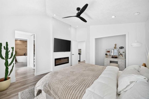 10909 Hidden Valley Drive Nw, Calgary, AB - Indoor Photo Showing Bedroom With Fireplace