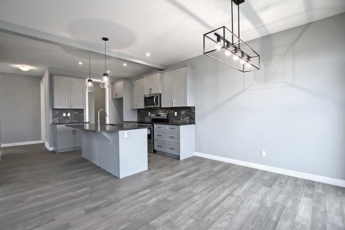 51 Agate Road, Cochrane, AB - Indoor Photo Showing Kitchen With Upgraded Kitchen