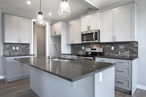 51 Agate Road, Cochrane, AB - Indoor Photo Showing Kitchen With Upgraded Kitchen