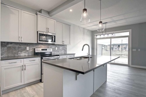 51 Agate Road, Cochrane, AB - Indoor Photo Showing Kitchen With Upgraded Kitchen