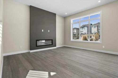 51 Agate Road, Cochrane, AB - Indoor Photo Showing Living Room With Fireplace