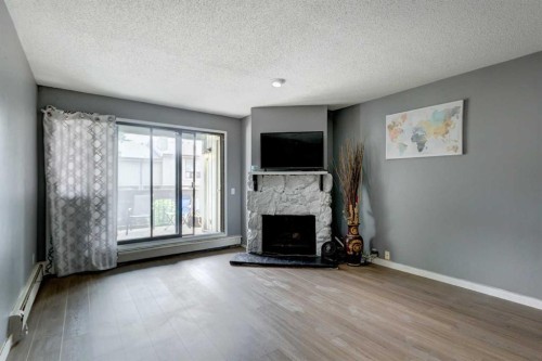 324-10120 Brookpark Boulevard Sw, Calgary, AB - Indoor Photo Showing Living Room With Fireplace