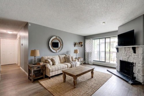 324-10120 Brookpark Boulevard Sw, Calgary, AB - Indoor Photo Showing Living Room With Fireplace