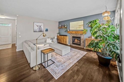 53 Heritage Drive, Cochrane, AB - Indoor Photo Showing Living Room With Fireplace