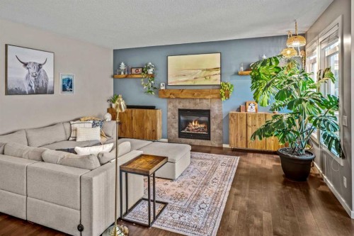 53 Heritage Drive, Cochrane, AB - Indoor Photo Showing Living Room With Fireplace