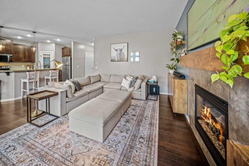 53 Heritage Drive, Cochrane, AB - Indoor Photo Showing Living Room With Fireplace