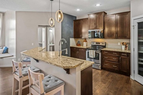 53 Heritage Drive, Cochrane, AB - Indoor Photo Showing Kitchen With Stainless Steel Kitchen With Upgraded Kitchen