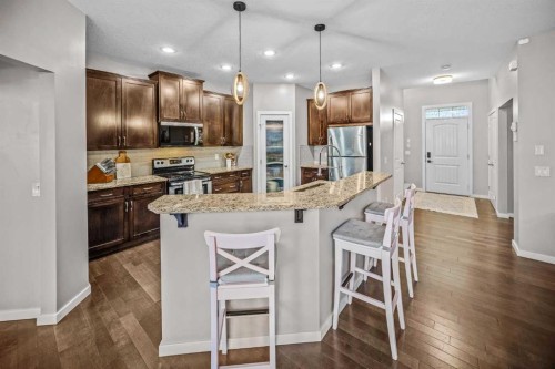53 Heritage Drive, Cochrane, AB - Indoor Photo Showing Kitchen With Stainless Steel Kitchen With Upgraded Kitchen