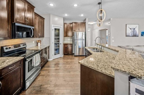 53 Heritage Drive, Cochrane, AB - Indoor Photo Showing Kitchen With Stainless Steel Kitchen With Double Sink With Upgraded Kitchen