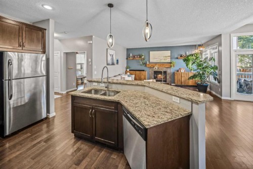 53 Heritage Drive, Cochrane, AB - Indoor Photo Showing Kitchen With Stainless Steel Kitchen With Double Sink With Upgraded Kitchen