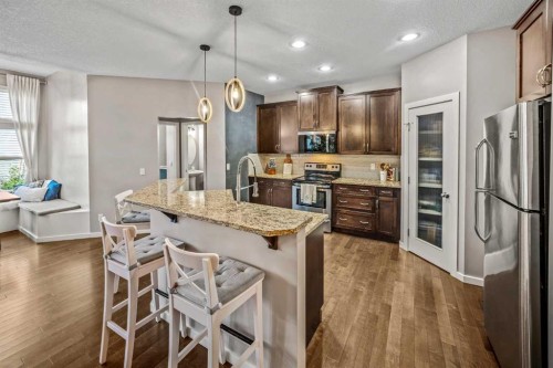 53 Heritage Drive, Cochrane, AB - Indoor Photo Showing Kitchen With Stainless Steel Kitchen With Upgraded Kitchen