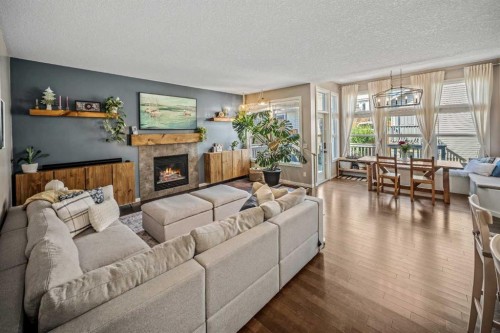 53 Heritage Drive, Cochrane, AB - Indoor Photo Showing Living Room With Fireplace