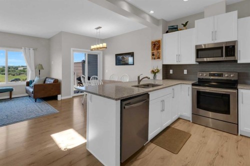 311 Sunrise View, Cochrane, AB - Indoor Photo Showing Kitchen With Stainless Steel Kitchen With Double Sink