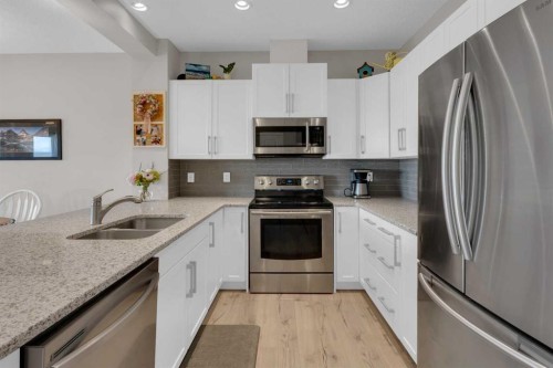 311 Sunrise View, Cochrane, AB - Indoor Photo Showing Kitchen With Stainless Steel Kitchen With Double Sink With Upgraded Kitchen