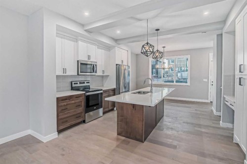 55 Agate Road, Cochrane, AB - Indoor Photo Showing Kitchen With Upgraded Kitchen