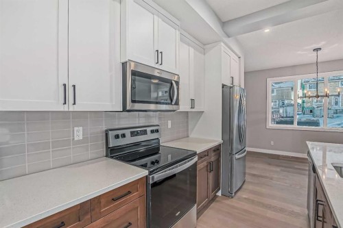 55 Agate Road, Cochrane, AB - Indoor Photo Showing Kitchen With Upgraded Kitchen