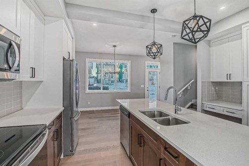 55 Agate Road, Cochrane, AB - Indoor Photo Showing Kitchen With Double Sink With Upgraded Kitchen