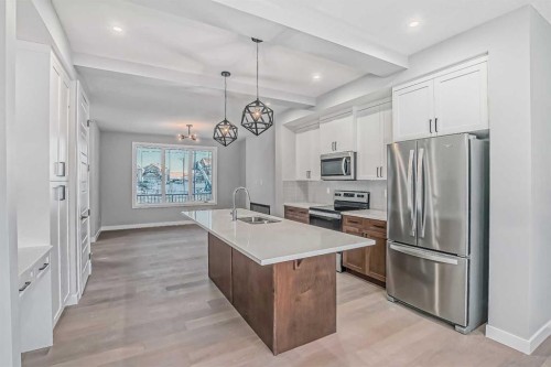 55 Agate Road, Cochrane, AB - Indoor Photo Showing Kitchen With Upgraded Kitchen