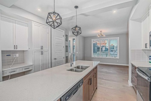 55 Agate Road, Cochrane, AB - Indoor Photo Showing Kitchen With Double Sink With Upgraded Kitchen
