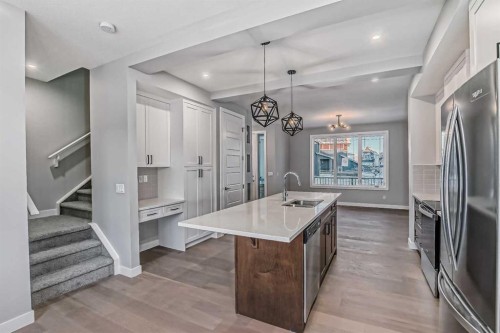 55 Agate Road, Cochrane, AB - Indoor Photo Showing Kitchen With Upgraded Kitchen