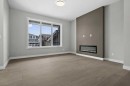 55 Agate Road, Cochrane, AB  - Indoor Photo Showing Living Room With Fireplace 