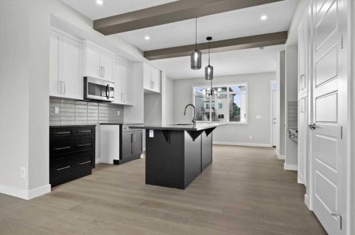 55 Agate Road, Cochrane, AB - Indoor Photo Showing Kitchen With Upgraded Kitchen